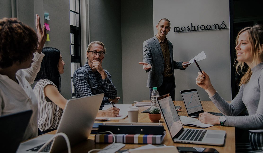 A group discussing plans around a meeting table